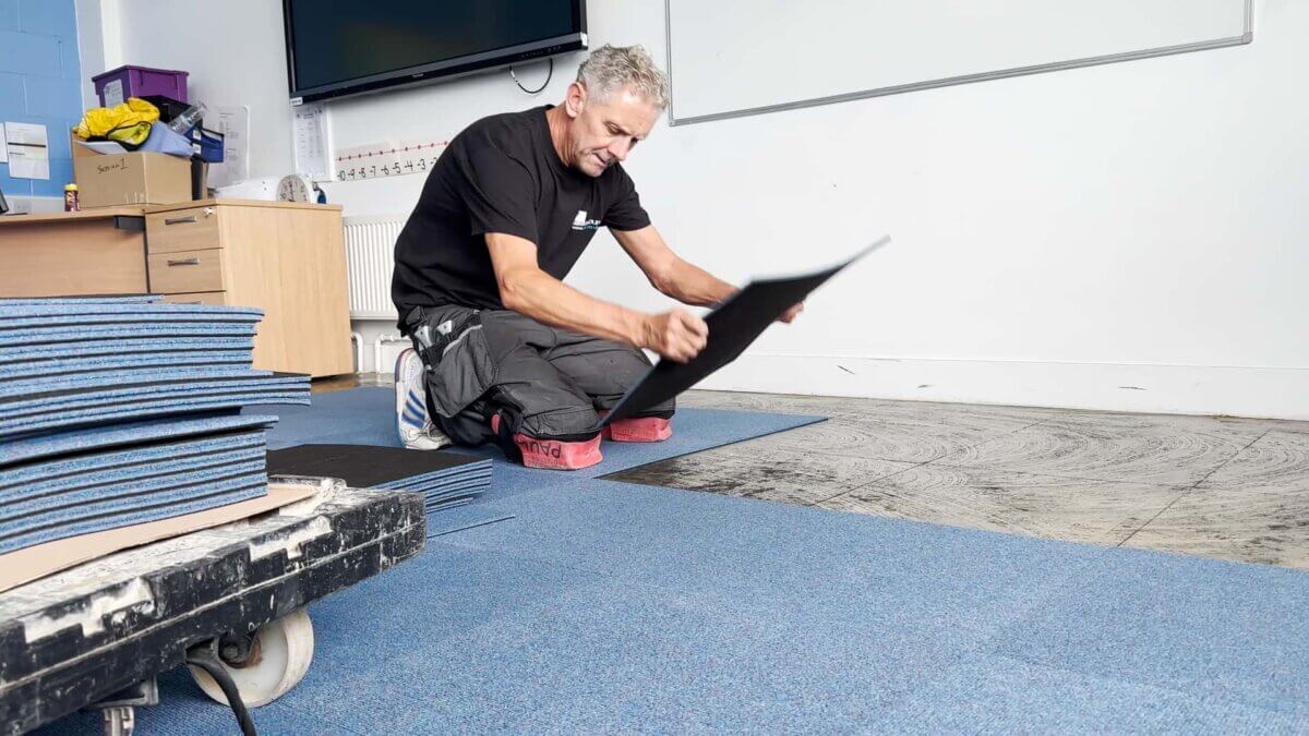 Laying carpet tiles at Wheelers Lane Technology College