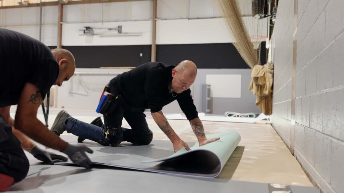 Laying the vinyl sports flooring at Langley School