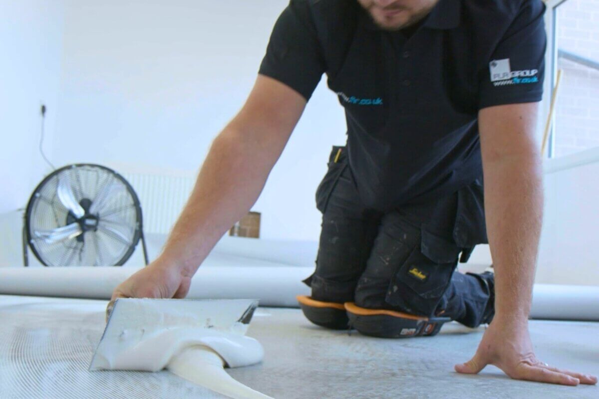 FLR Group fitter applying adhesive to the floor