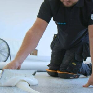 FLR Group fitter applying adhesive to the floor