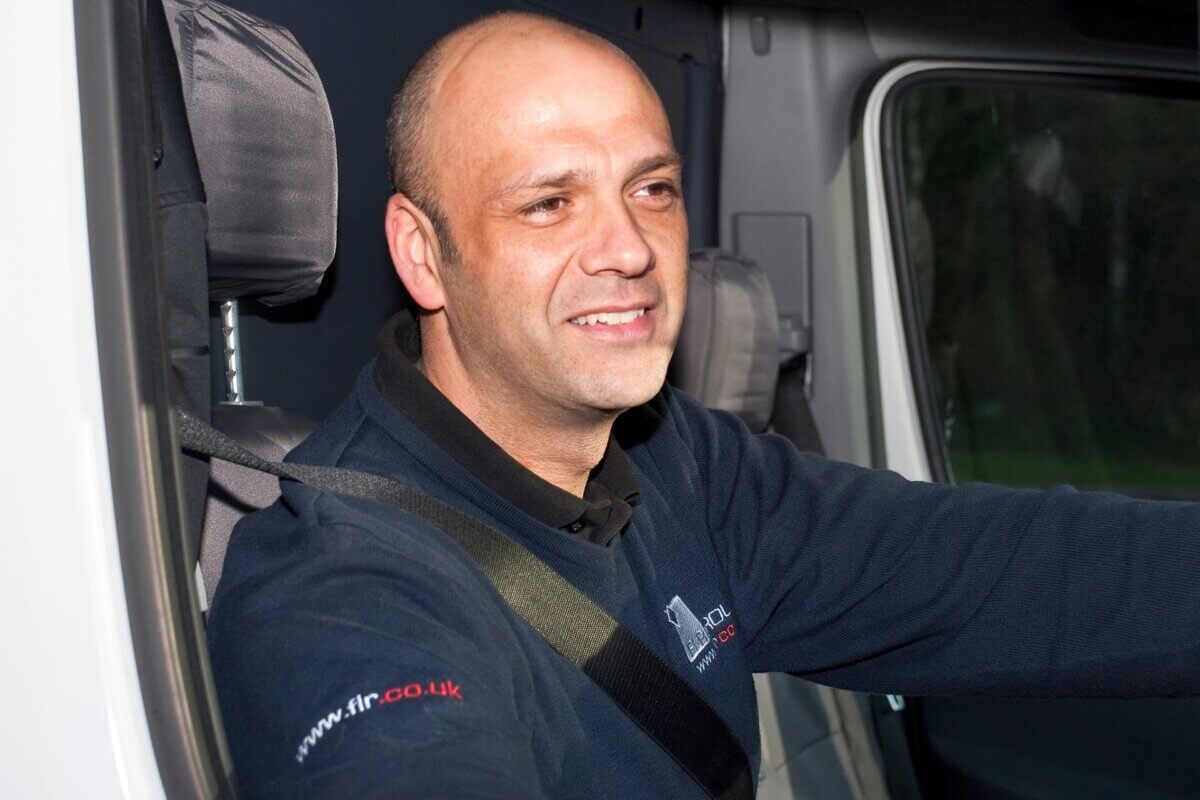 Shot of flooring installer in work van