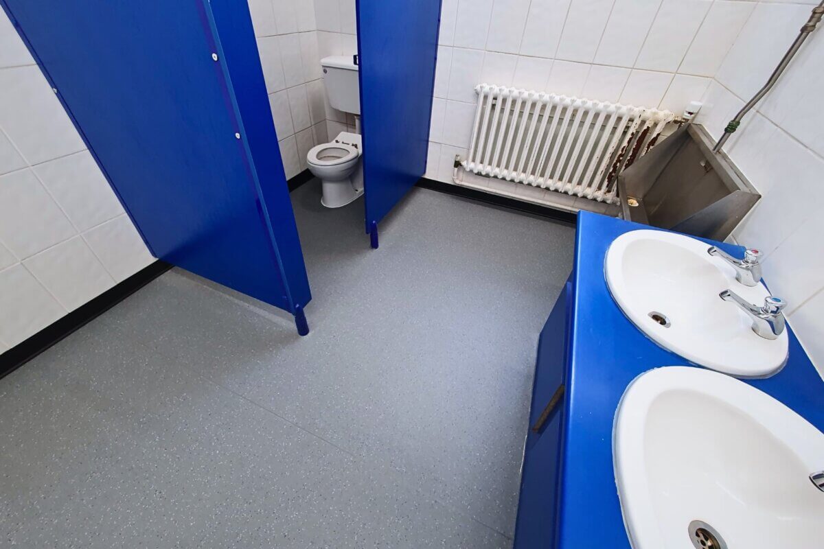 Interior shot of school toilet showing safety vinyl