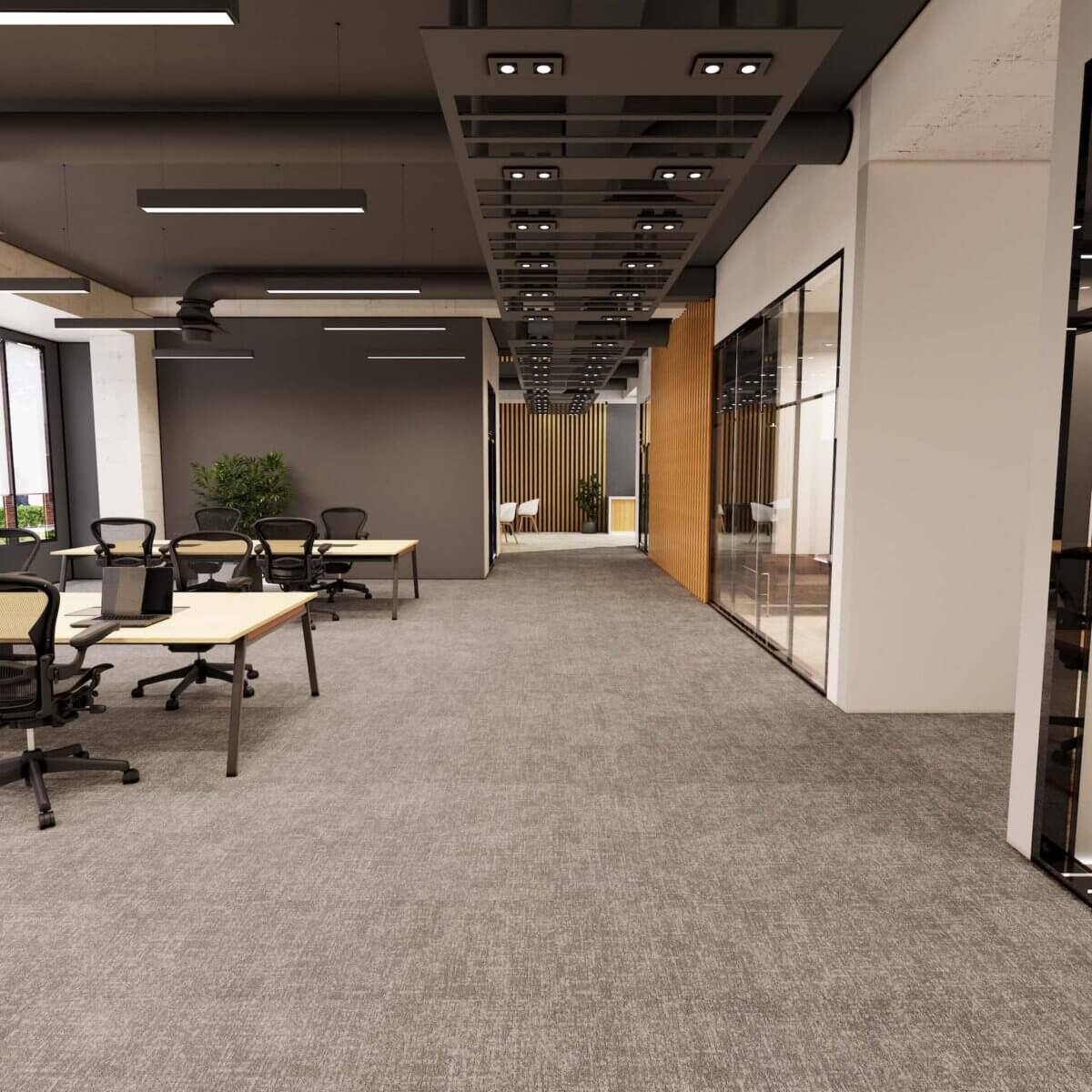 Modern open-plan office interior featuring contemporary workspace design with desks, glazed meeting rooms and linear ceiling lighting, finished with grey Milliken carpet tiles providing a sleek, durable and acoustically comfortable flooring solution.